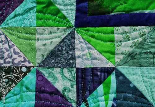 Patchwork quilting close-up in cozy handcrafted style, multicolor fabric textures, creative textile design background