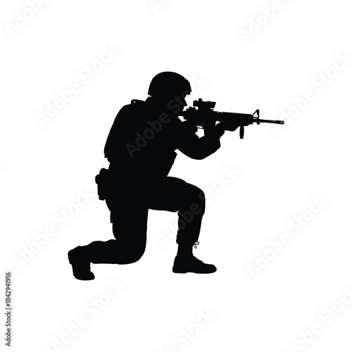 Silhouette of a soldier in full tactical gear kneeling and taking aim with a modern assault rifle