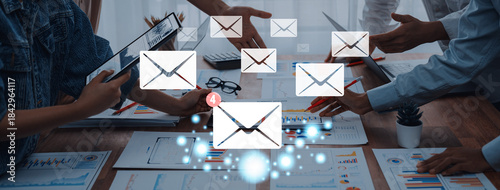 Obraz na plátne Capturing a dynamic team collaboration scene, this image illustrates digital communication with emails and analysis, emphasizing synergy in the modern office environment
