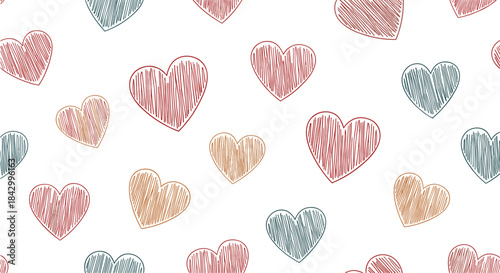Delightful seamless pattern featuring a playful assortment of hand-drawn, scribbled hearts in various sizes and warm, appealing colors.