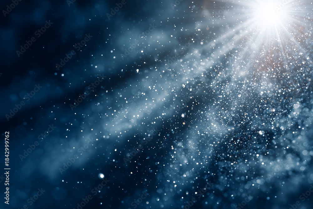 Fototapeta premium Blurred dark blue background with shiny glitter particles and sun rays, concept for Christmas, New Year and celebration
