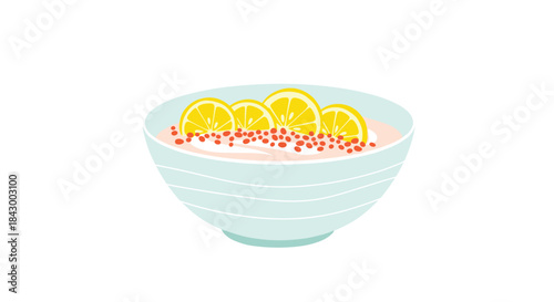 Light blue ceramic bowl holds pale pink lemonade with lemon slices and red seeds for a bright refreshing summer drink and a playful table presentation.