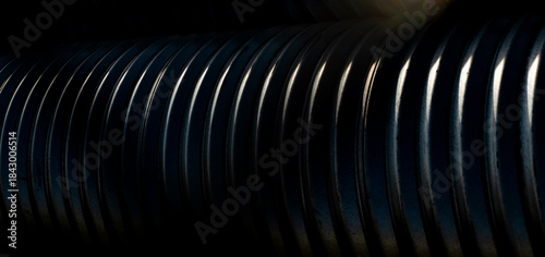 Detailed panorama of an industrial steel culvert with dramatic sidelight highlighting the ribs