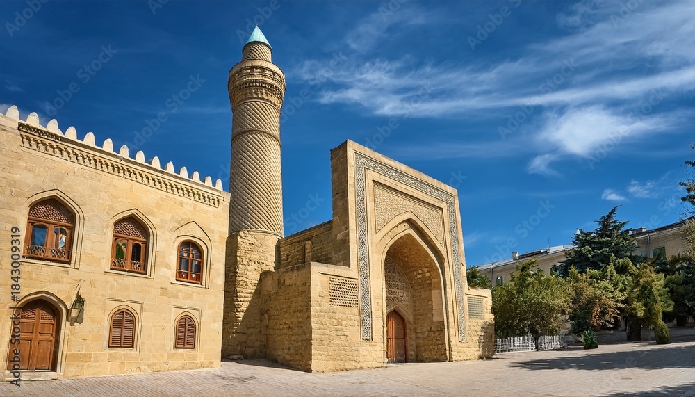 Obraz premium beige stone building featuring a tall cylindrical minaret baku azerbaijan