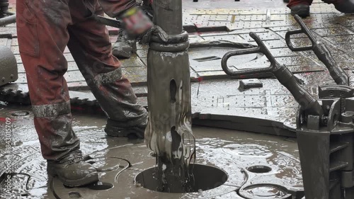 Drilling rig activity - Pull of of hole drill string with oil based mud on the rig floor.
