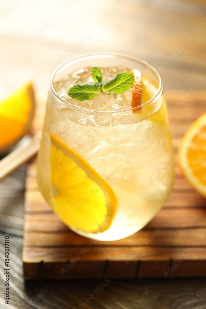 Fototapeta premium Refreshing spritzer cocktail with mint on wooden table, closeup