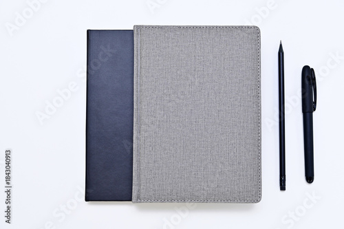 notebooks, pen and pencil on white background flat lay
