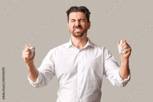 Angry businessman with crum...