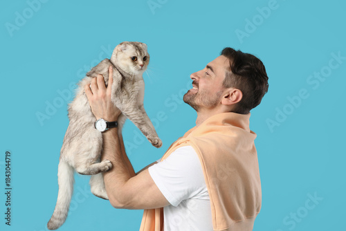 Young man holding cute Scot...