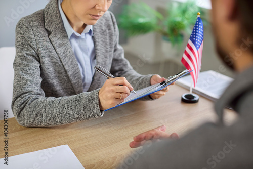 Canvas Print Consular visa interview with USA officer reviewing documents in public services or embassy