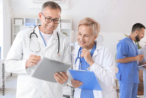 Mature doctors with clipboa...