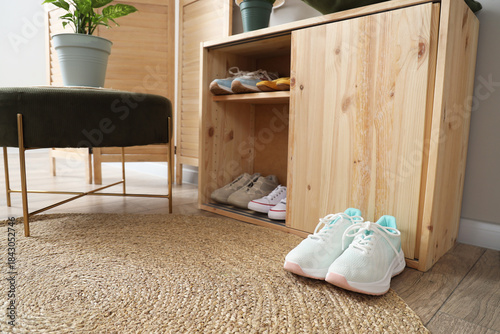 Wooden stand with shoes in ...