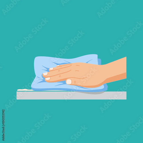 Hand wiping a surface with a blue cloth cleaning up spilled liquid.