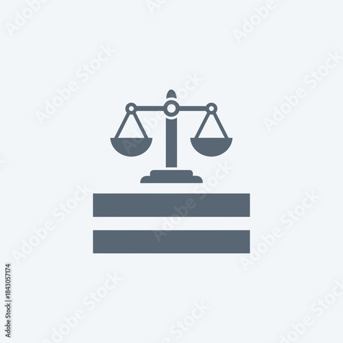 A balance scale rests on a two-tiered base.