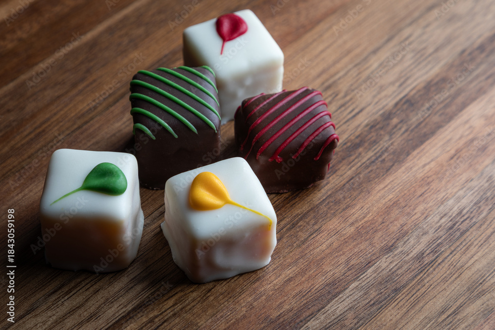 custom made wallpaper toronto digitalAn elegant arrangement of artisan white chocolate squares, beautifully decorated and presented on a rustic wooden board. Perfect for gifts and celebrations.