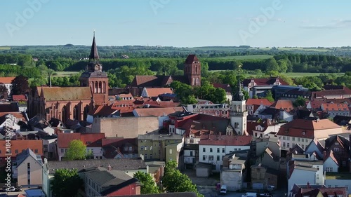 Wallpaper Mural Telephoto aerial view over Güstrow city center, looking toward surrounding hills and Island Lake, showing rooftops and historic urban landscape. Torontodigital.ca