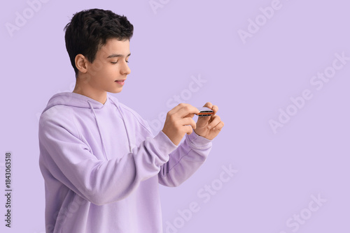 Teenage boy with harmonica ...