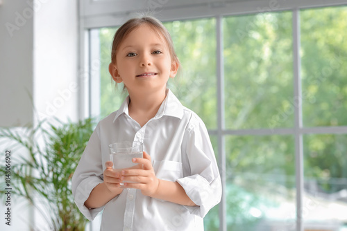 Cute little girl with glass...