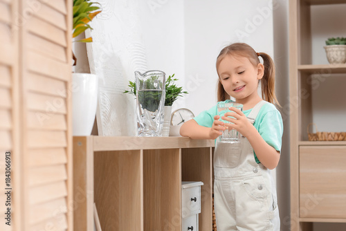 Cute little girl with glass...