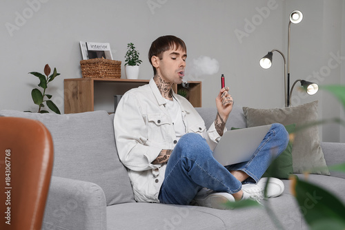 Young man smoking disposabl...