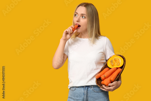 Young woman eating carrot o...