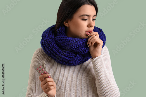 Sick young woman with pills...