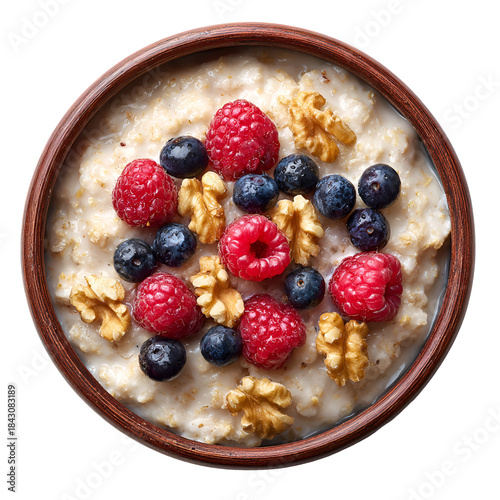 Healthy oatmeal bowl topped with fresh berries and walnuts