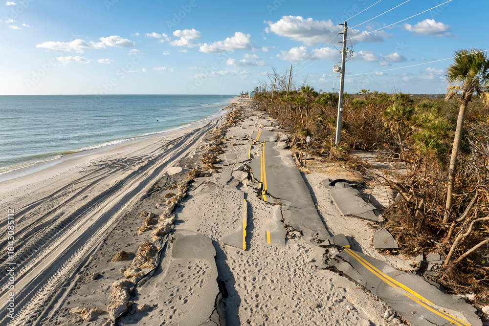 Naklejka premium Road erosion after hurricane in Florida. Storm surge washed away asphalt on Manasota Key road at Blind Pass Beach. Severe damage to waterfront infrastructure