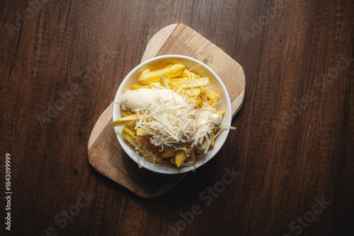 french fries with truffle mayonaise and cheese on top
