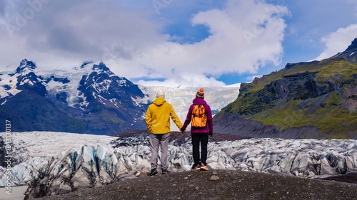 Svinafellsjokull Glacier, Iceland. A couple of men and women walking on a glacier in Iceland Svinafellsjokull Glacier Iceland. 
