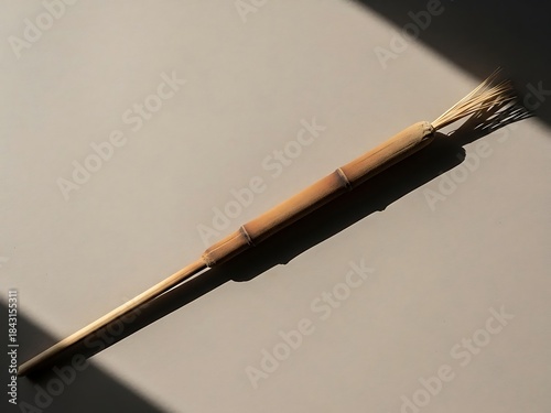 Still life of a handmade cleaning brush on a neutral shaded background