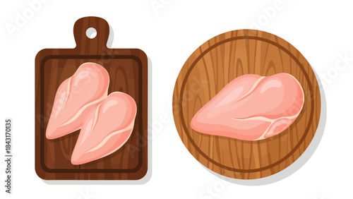 Fresh raw chicken is displayed on wooden surfaces, with two fillets arranged on a dark rectangular cutting board and a large butterfly-cut breast centered on a round, lighter-toned chopping block