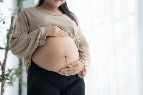 Free Download Pregnant woman holds hands on belly touching her baby caring about her health Beautiful happy pregnant woman 
tender mood photo of pregnancy - GFXLoad