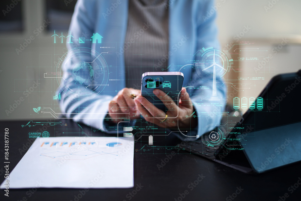 Fototapeta premium Woman using futuristic interface with smart tech and mobile to manage ESG, clean energy, and sustainability data.