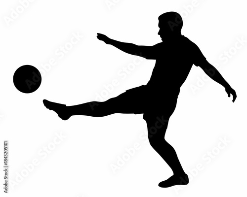 Silhouette of a soccer player kicking the ball during a dynamic game