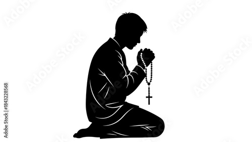 Man kneeling in prayer with rosary beads in a moment of silent reflection