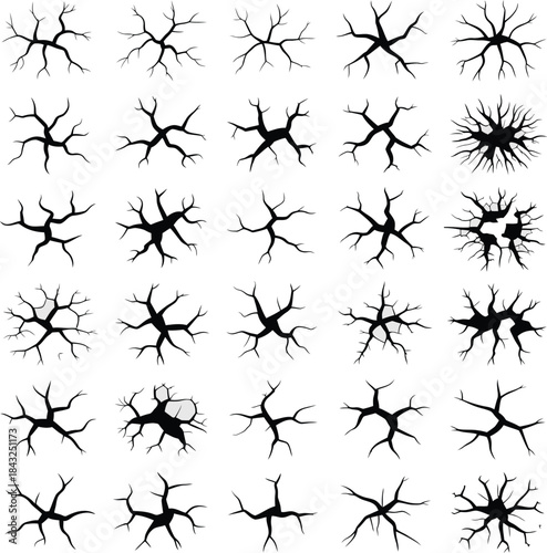 Collection of black crack and fissure silhouettes on white background, design elements