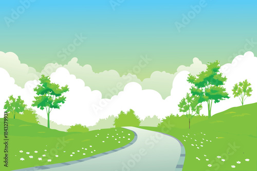 A winding gray pathway leads through a vibrant green landscape with fluffy