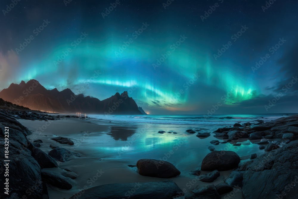 Naklejka premium Aurora Borealis Illuminating Night Sky Over Rocky Beach Landscape