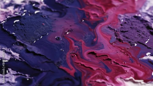 Abstract swirling paint colors blending together with glossy texture