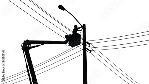 Silhouette of Electrician Technician Working on Utility Pole Repairing Street Light in Boom Lift Bucket