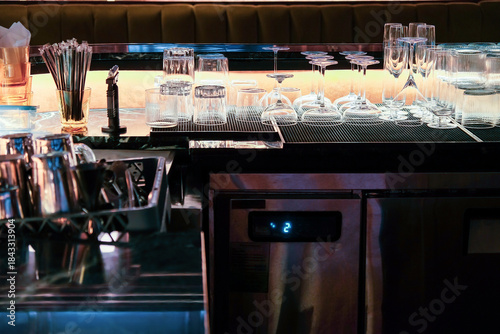 Coffee shop interior with barista equipment and glassware.