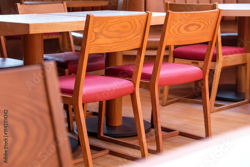 Wooden chairs and tables in a cafe, closeup of photo