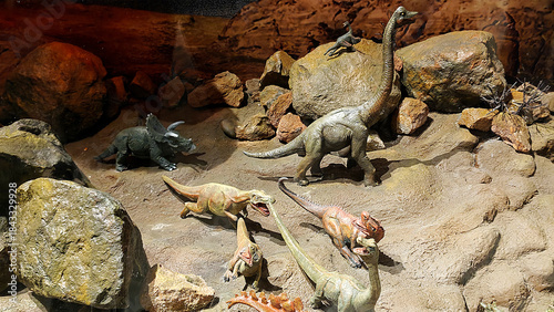 Dinosaurs running among falling rocks