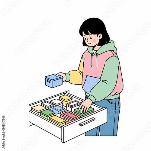 Organized drawer with a young woman placing small containers, showcasing efficient storage solutions for everyday items