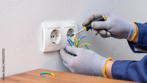 Photos electrician installing electrical outlet