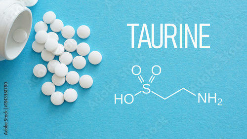 Taurine white medical pills spilling out of a drug bottle. Chemical structure of Taurine