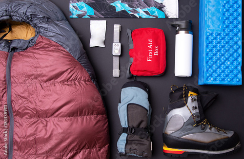 Flat lay of winter outdoor survival gear, alpine hiking safety and expedition essentials.