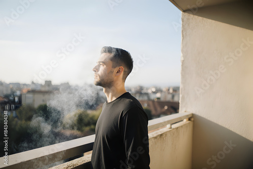 Wallpaper Mural Side Profile Of Man Exhaling Smoke On Balcony During Sunset Torontodigital.ca