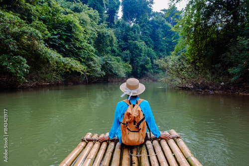 фотографія Journey through the serene landscape of Khao Sok, Thailand, as a traveler enjoys bamboo rafting